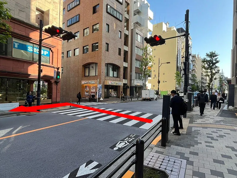 Cross the crosswalk and turn left.